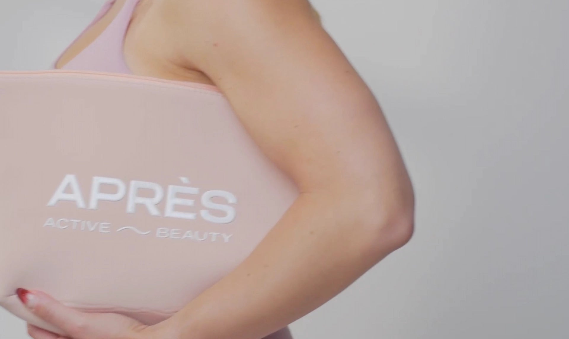 a woman wearing a pink bag